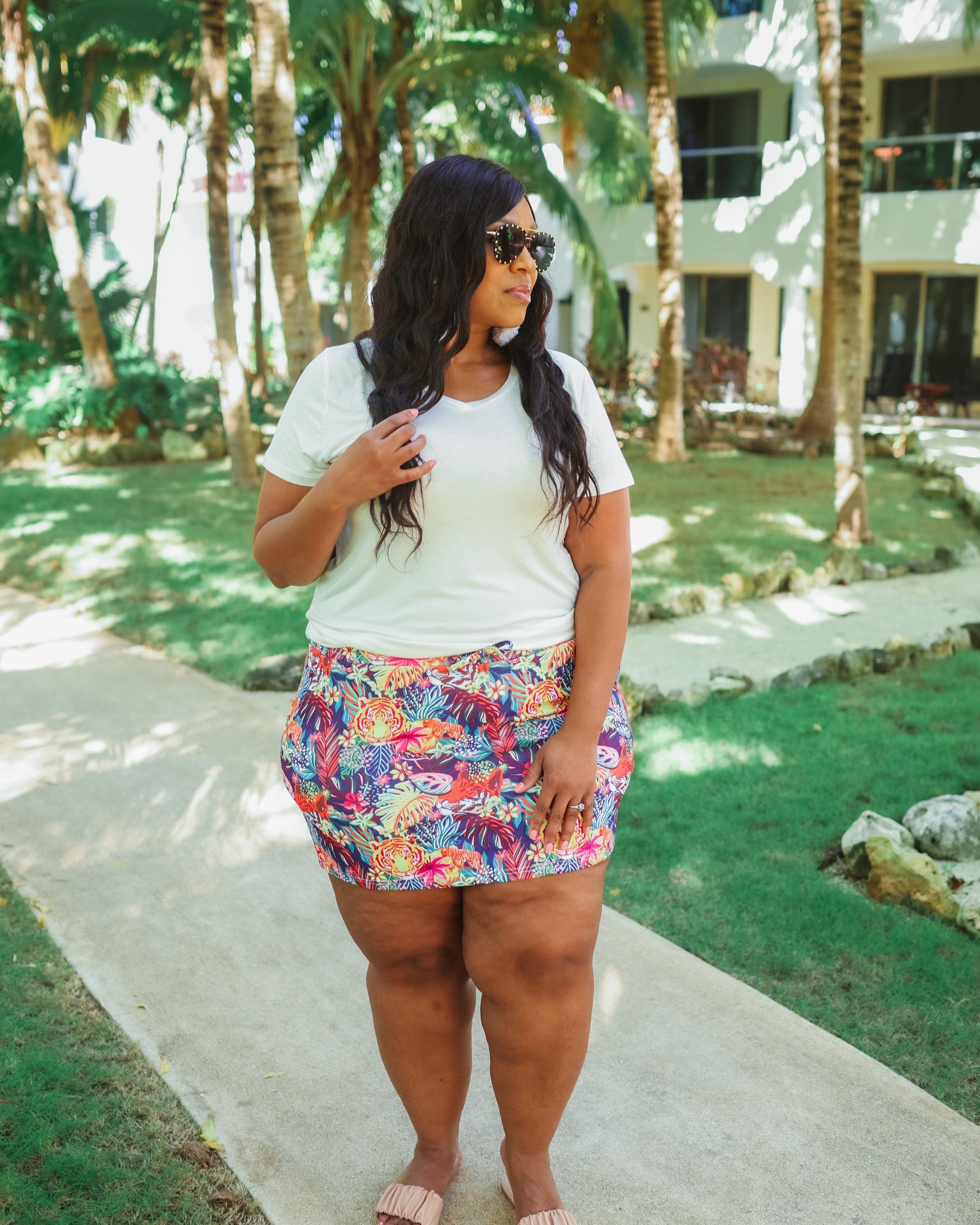 mid-rise relaxed fit everyday skort made of lightweight material with built-in ivory shorts, drawstring tie, an elastic band on the back, and side pockets, designed on a vibrant wild cat and jungle pattern print fabric and navy base