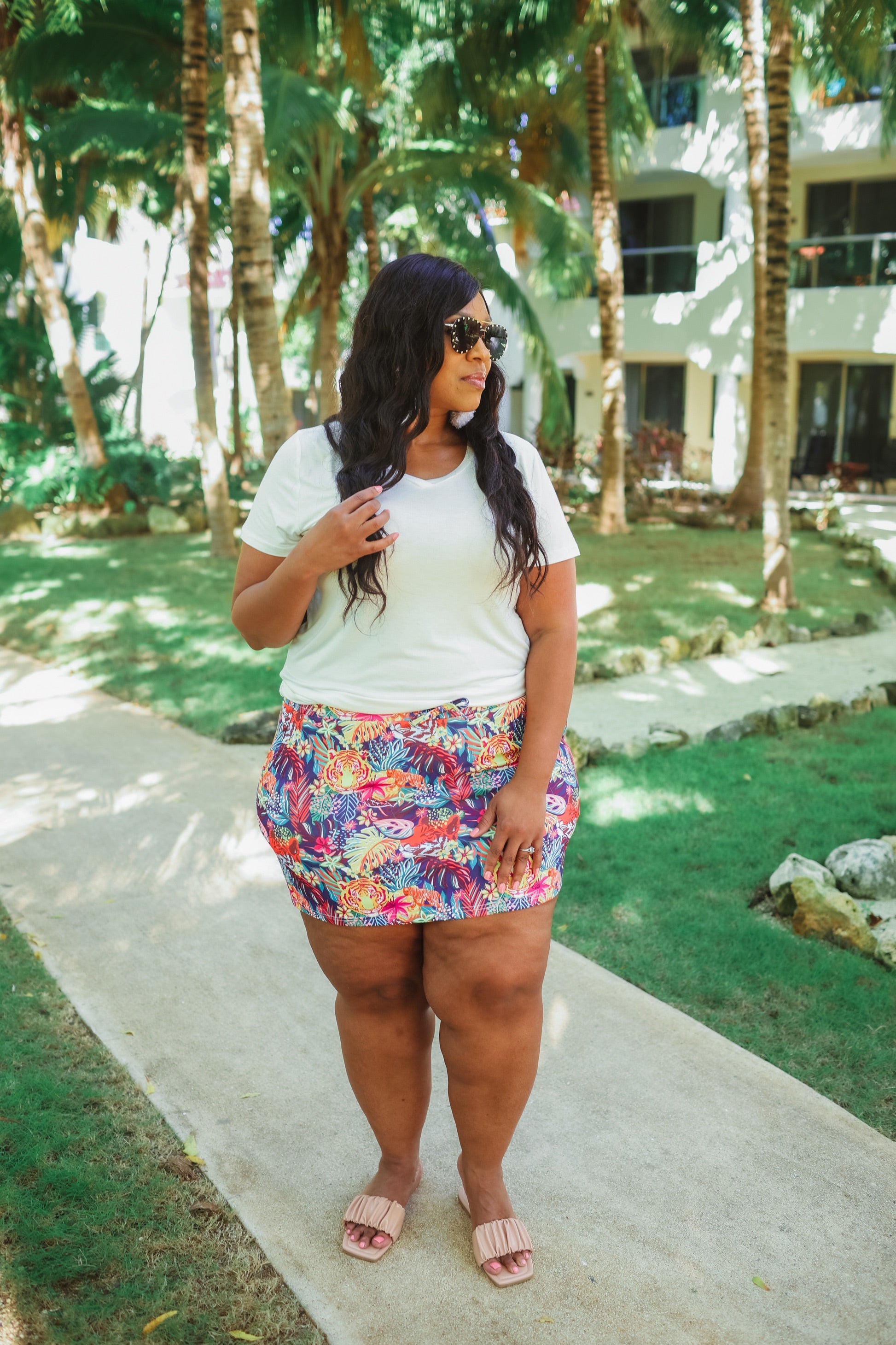 mid-rise relaxed fit everyday skort made of lightweight material with built-in ivory shorts, drawstring tie, an elastic band on the back, and side pockets, designed on a vibrant wild cat and jungle pattern print fabric and navy base