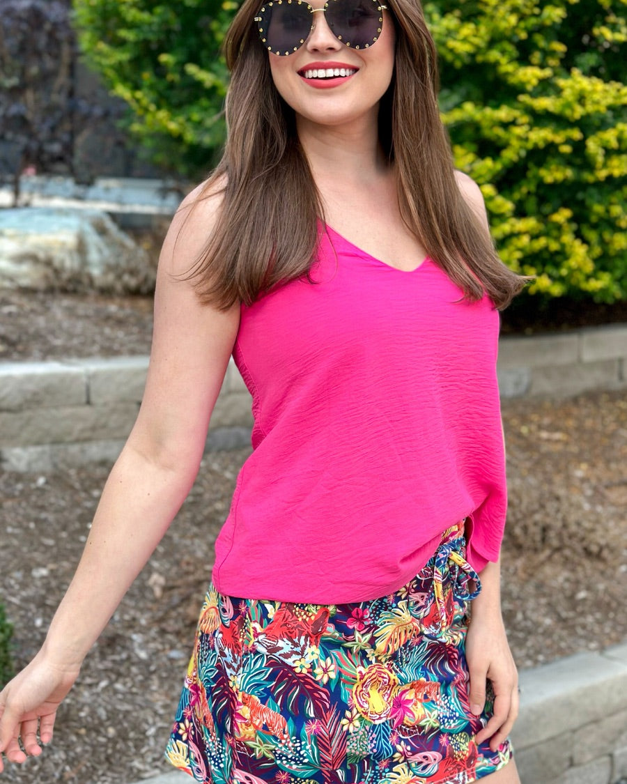 mid-rise relaxed fit everyday skort made of lightweight material with built-in ivory shorts, drawstring tie, an elastic band on the back, and side pockets, designed on a vibrant wild cat and jungle pattern print fabric and navy base