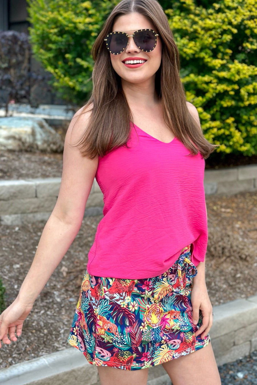 mid-rise relaxed fit everyday skort made of lightweight material with built-in ivory shorts, drawstring tie, an elastic band on the back, and side pockets, designed on a vibrant wild cat and jungle pattern print fabric and navy base