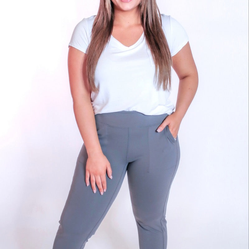 grey high-rise joggers crafted on smooth stretch fabric with a 3" waistband, side pockets, interior waistband back pocket, contoured back seam detail, tapered leg, and cuffed ankles