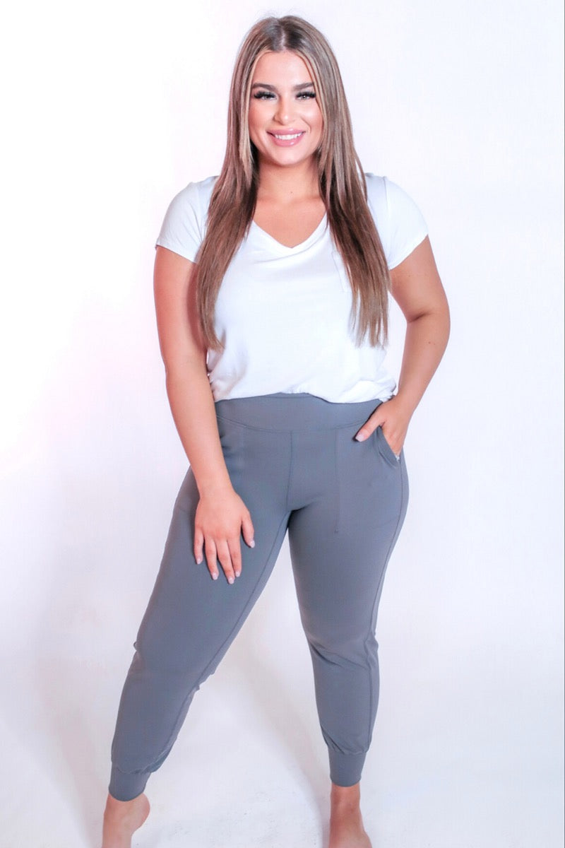 grey high-rise joggers crafted on smooth stretch fabric with a 3" waistband, side pockets, interior waistband back pocket, contoured back seam detail, tapered leg, and cuffed ankles