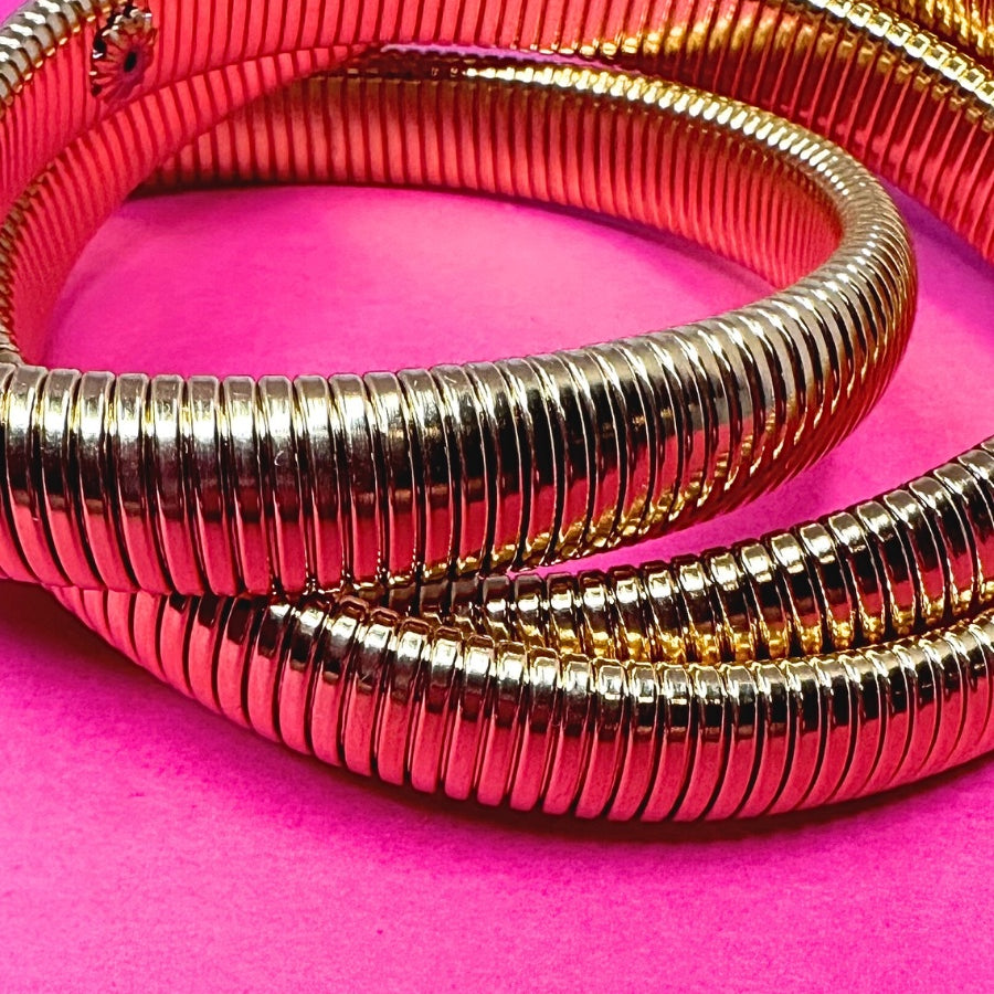 three intertwined stretch bands with a slip-on design in gold