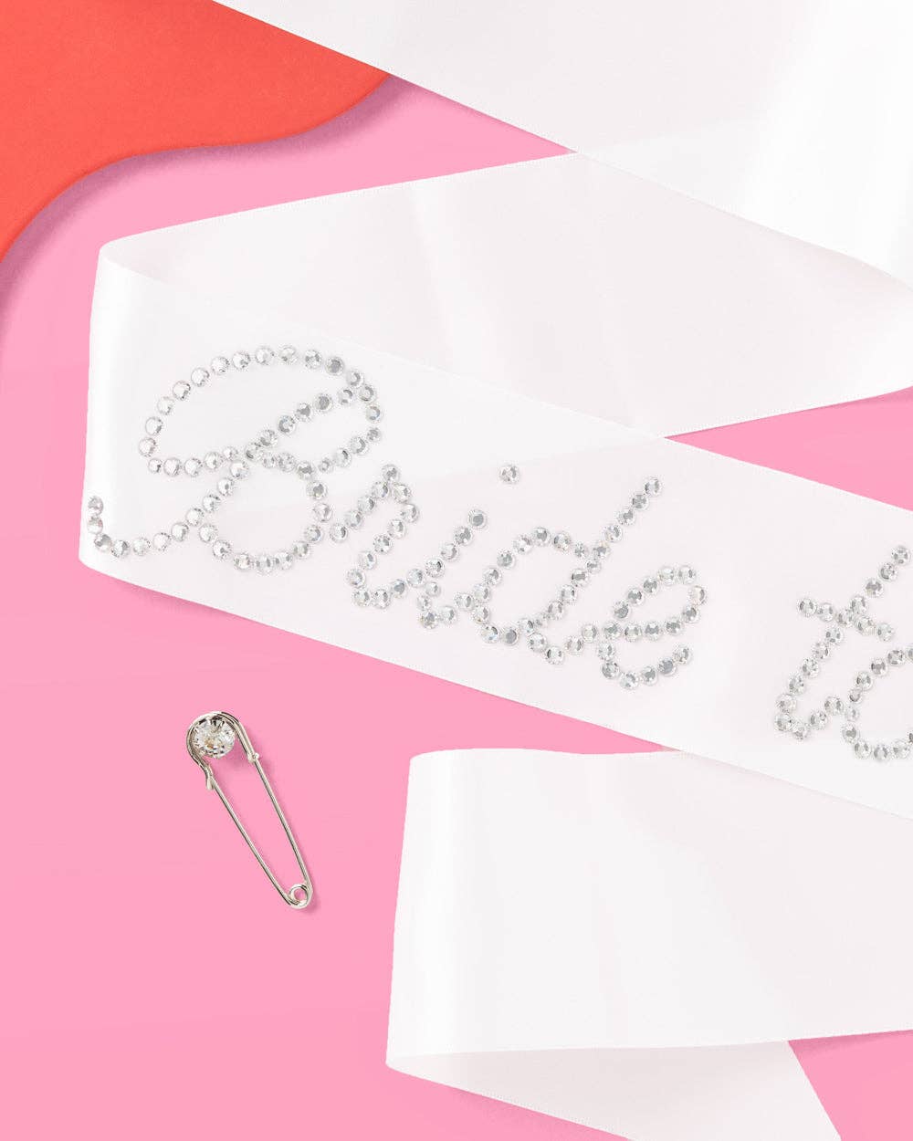 Bride sash with rhinestone accents on a pink background