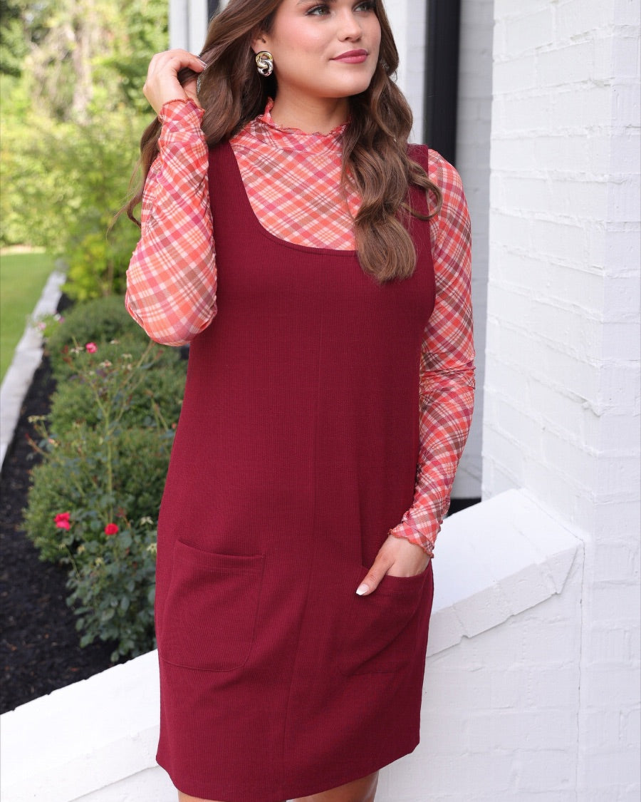 sleeveless ribbed dress with a scoop neckline, front patch pockets, and a relaxed silhouette in burgundy