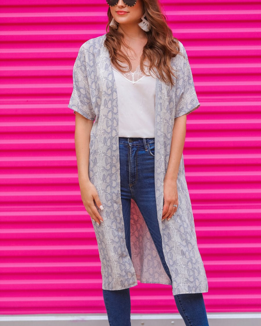 an open front kimono made of lightweight material with loose short sleeves on a subtle snake print pattern