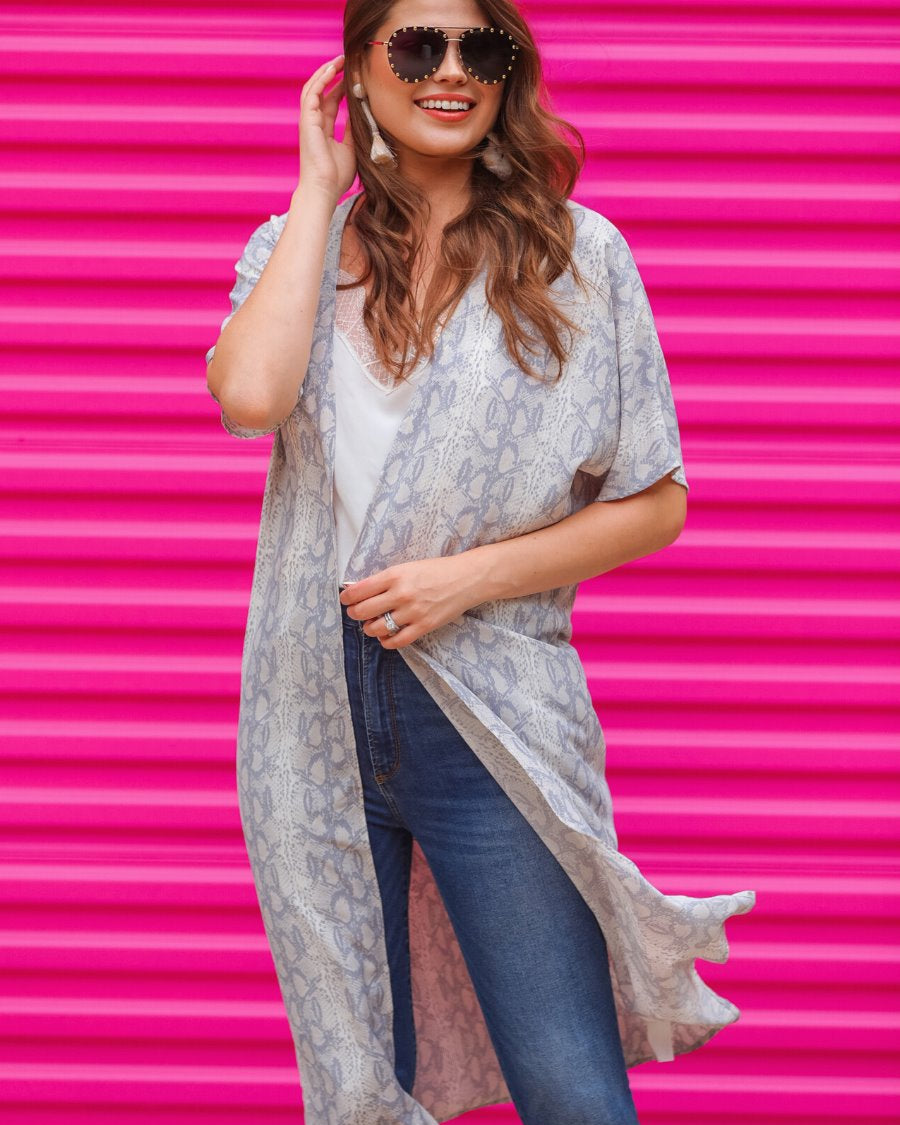 an open front kimono made of lightweight material with loose short sleeves on a subtle snake print pattern