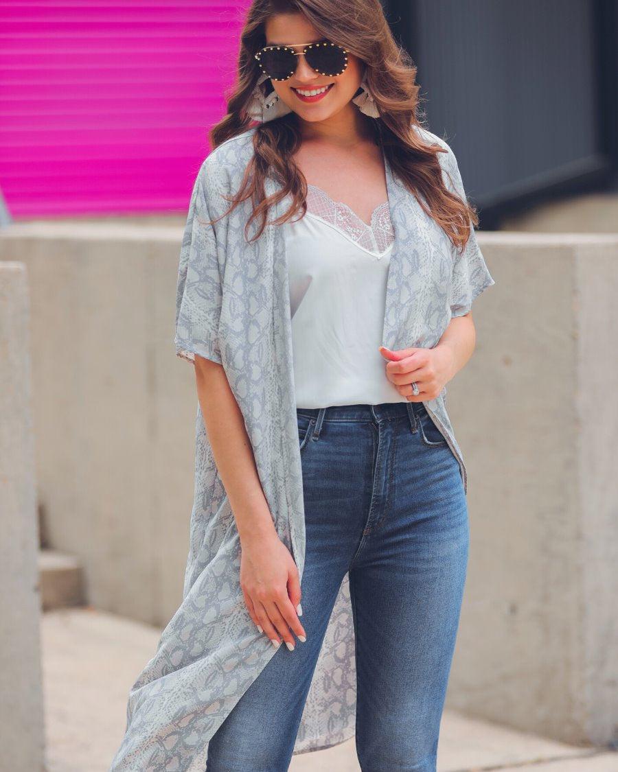 an open front kimono made of lightweight material with loose short sleeves on a subtle snake print pattern