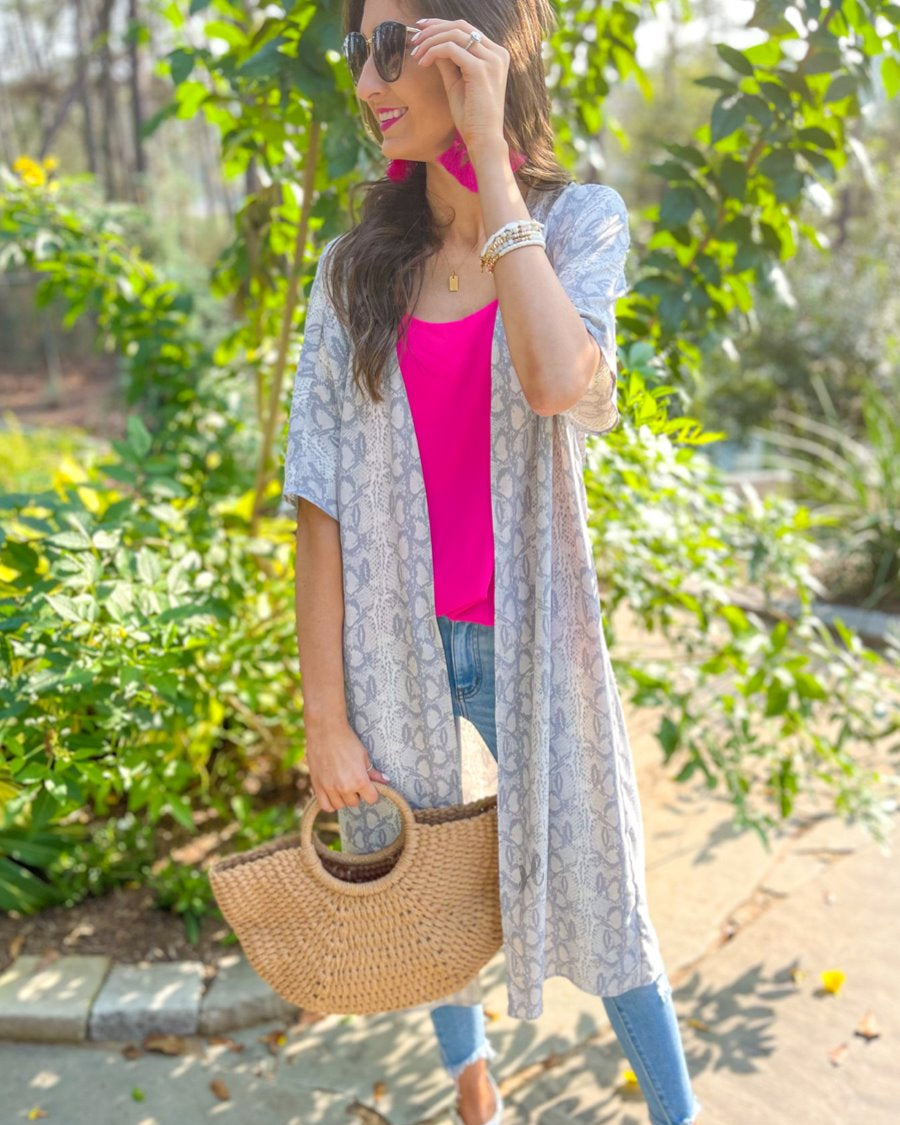 an open front kimono made of lightweight material with loose short sleeves on a subtle snake print pattern