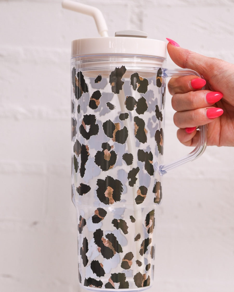 40-ounce black and brown animal print acrylic tumbler with a reusable straw (ivory), flexible mouthpiece (ivory), handle, screw-on lid (ivory with a grey rotate lid tab), and car cup holder compatible