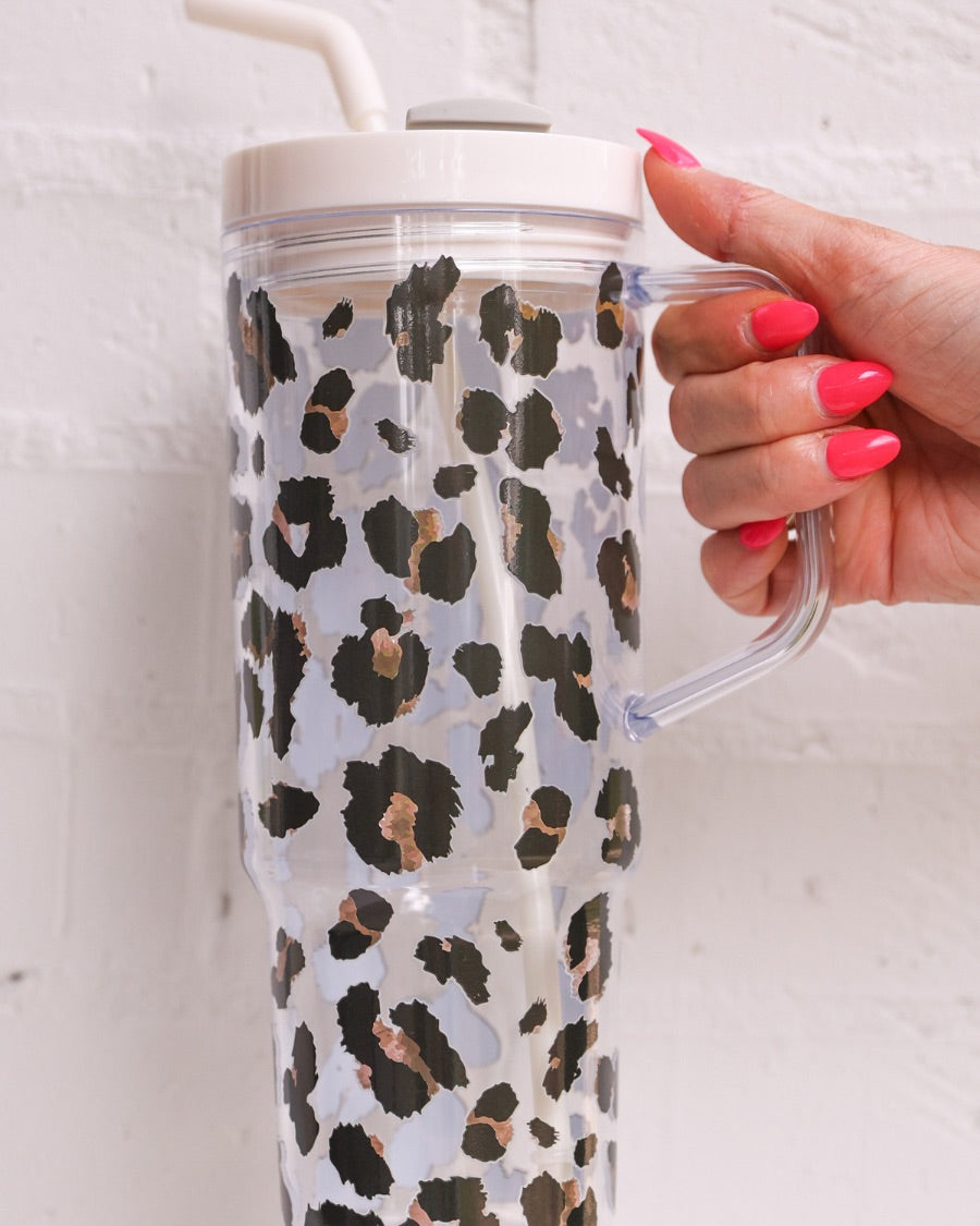 40-ounce black and brown animal print acrylic tumbler with a reusable straw (ivory), flexible mouthpiece (ivory), handle, screw-on lid (ivory with a grey rotate lid tab), and car cup holder compatible