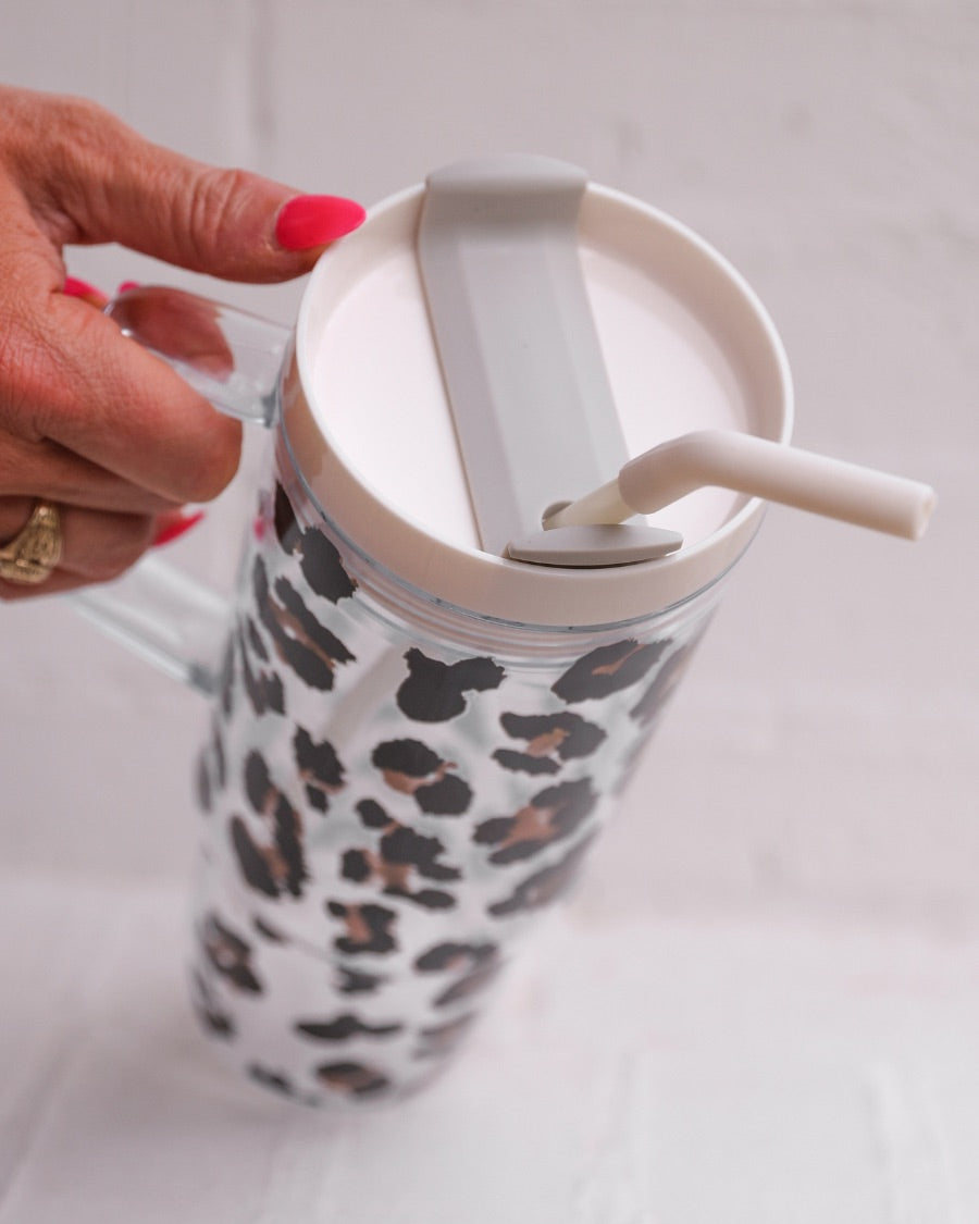 40-ounce black and brown animal print acrylic tumbler with a reusable straw (ivory), flexible mouthpiece (ivory), handle, screw-on lid (ivory with a grey rotate lid tab), and car cup holder compatible
