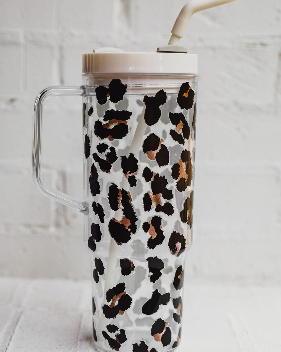 40-ounce black and brown animal print acrylic tumbler with a reusable straw (ivory), flexible mouthpiece (ivory), handle, screw-on lid (ivory with a grey rotate lid tab), and car cup holder compatible