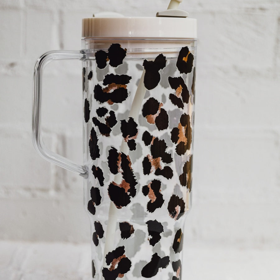 40-ounce black and brown animal print acrylic tumbler with a reusable straw (ivory), flexible mouthpiece (ivory), handle, screw-on lid (ivory with a grey rotate lid tab), and car cup holder compatible