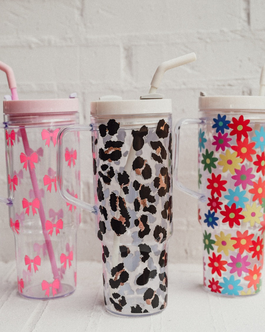 40-ounce pink bows, animal. print, and flowers pattern acrylic tumblers with a reusable clear straw, flexible mouthpiece, handle, screw-on lid, and car cup holder compatible