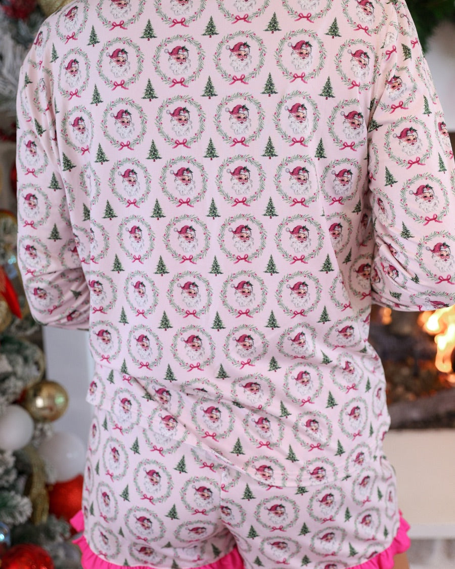 long sleeve top and matching shorts on a custom-designed solid light pink fabric with a vintage Santa pattern and Christmas tree