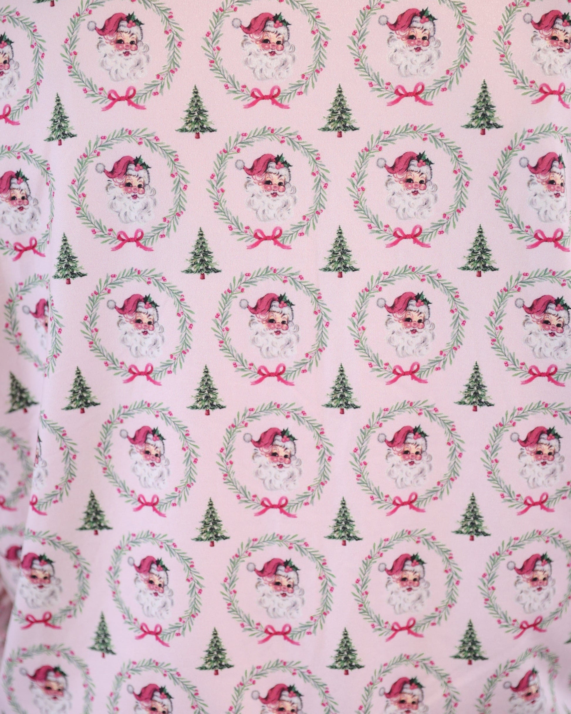 long sleeve top and matching shorts on a custom-designed solid light pink fabric with a vintage Santa pattern and Christmas tree