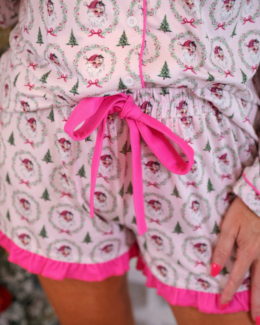 long sleeve top and matching shorts on a custom-designed solid light pink fabric with a vintage Santa pattern and Christmas tree