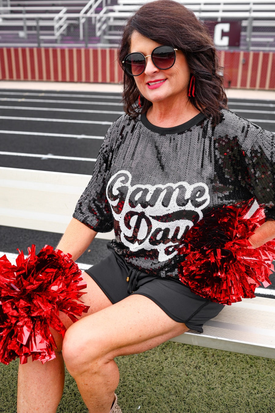a full sequin design top on a solid color with the words 'Game Day" on the center front outlined in white sequins, a boxy fit, and a lined interior in black