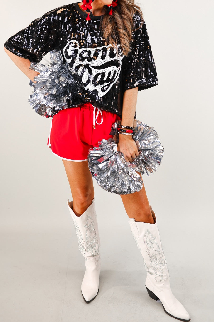 a full sequin design top on a solid color with the words 'Game Day" on the center front outlined in white sequins, a boxy fit, and a lined interior in black