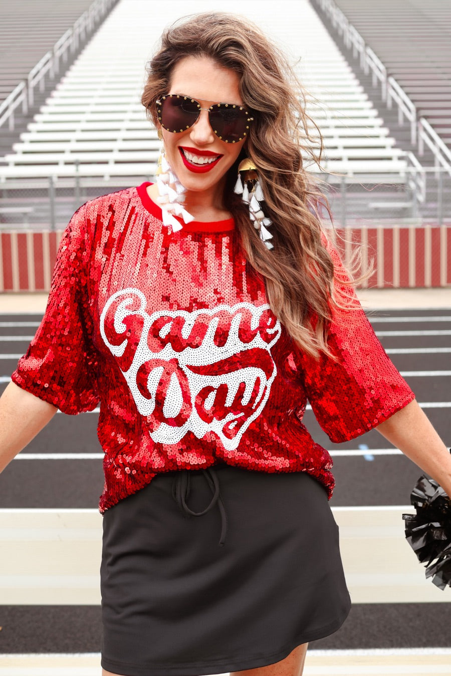 a full sequin design top on a solid color with the words 'Game Day" on the center front outlined in white sequins, a boxy fit, and a lined interior in red
