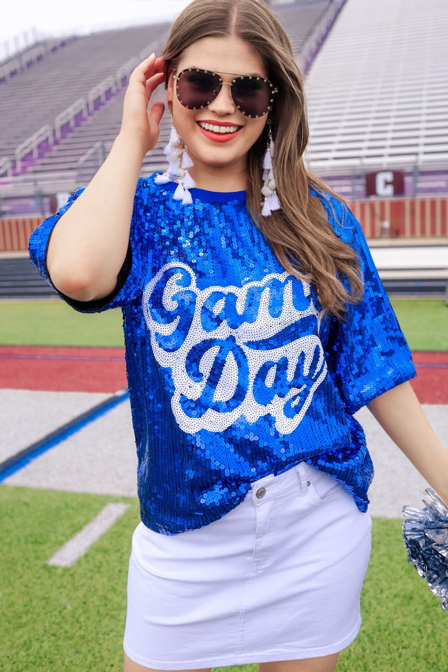 a full sequin design top on a solid color with the words 'Game Day" on the center front outlined in white sequins, a boxy fit, and a lined interior in royal blue