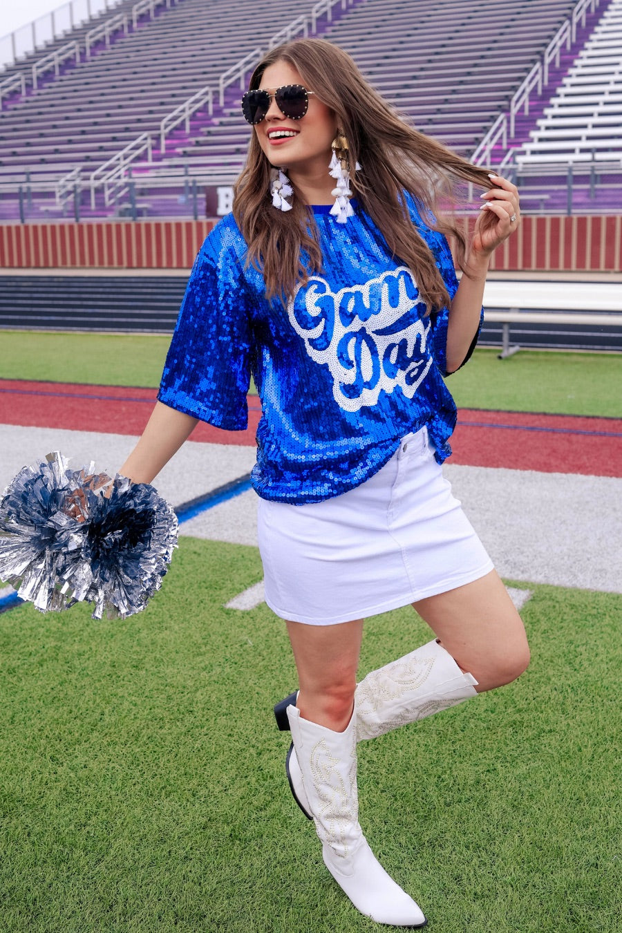 a full sequin design top on a solid color with the words 'Game Day" on the center front outlined in white sequins, a boxy fit, and a lined interior in royal blue