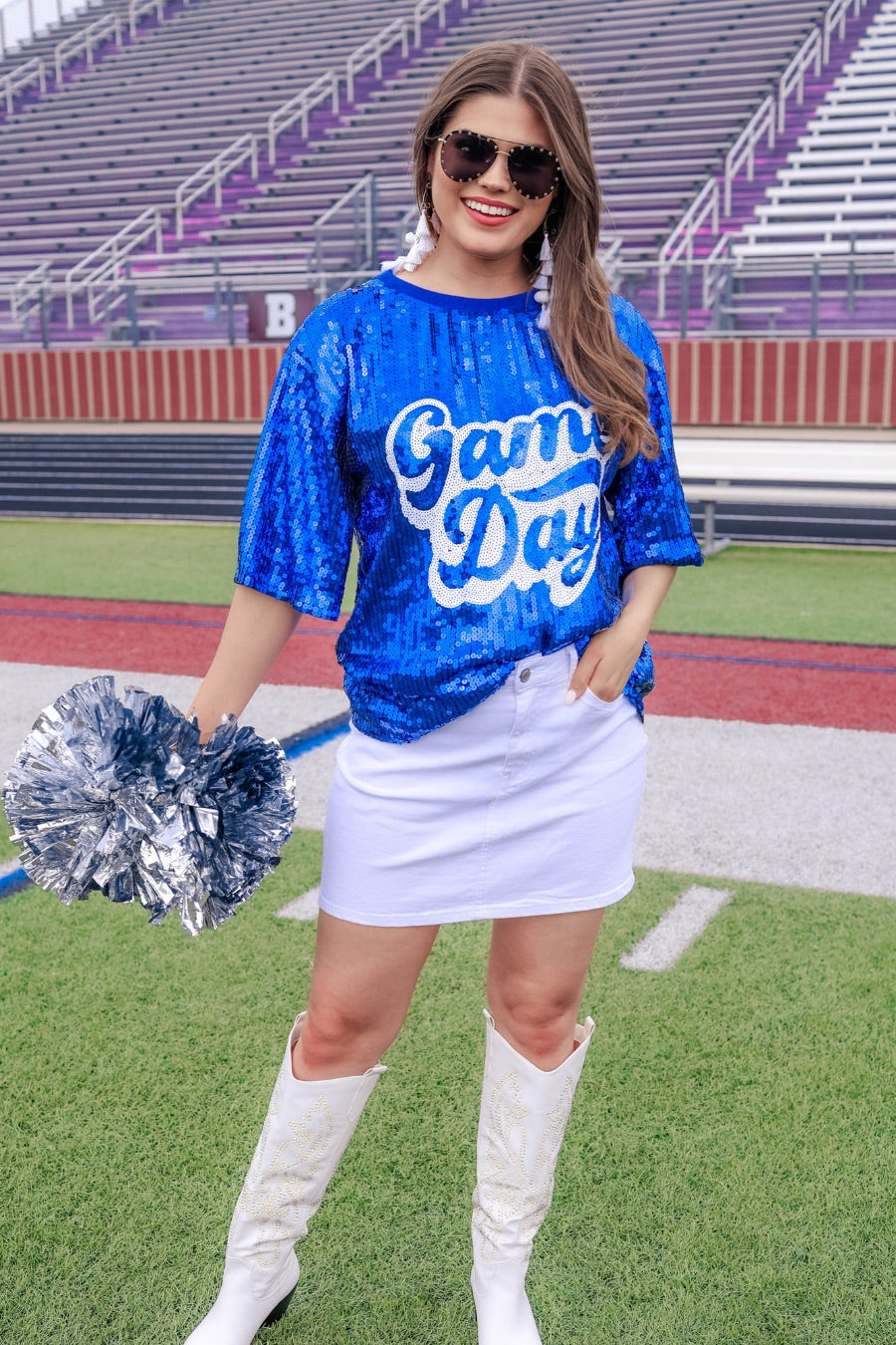 a full sequin design top on a solid color with the words 'Game Day" on the center front outlined in white sequins, a boxy fit, and a lined interior in royal blue