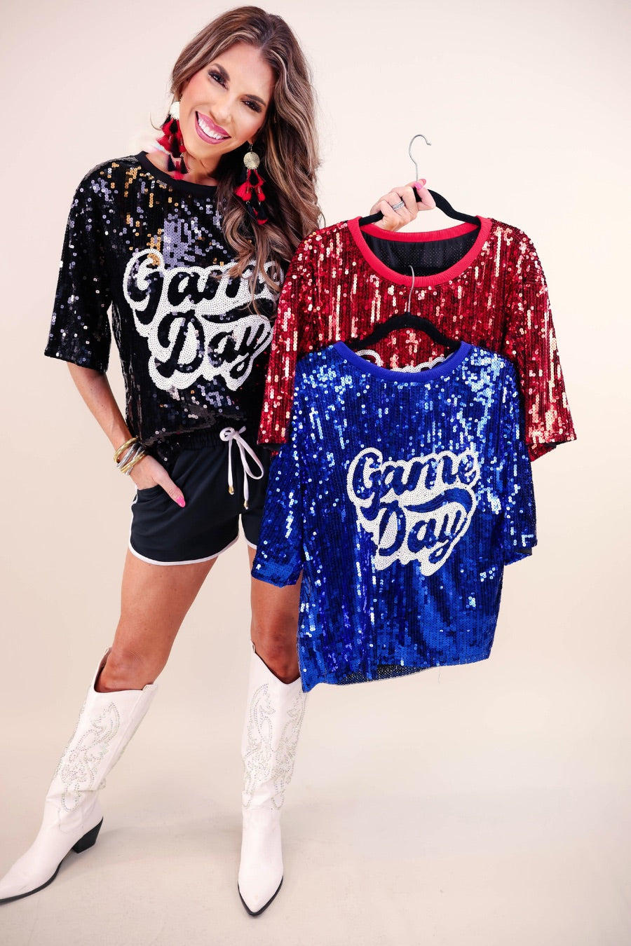 a full sequin design top on a solid color with the words 'Game Day" on the center front outlined in white sequins, a boxy fit, and a lined interior in black, red, and royal blue