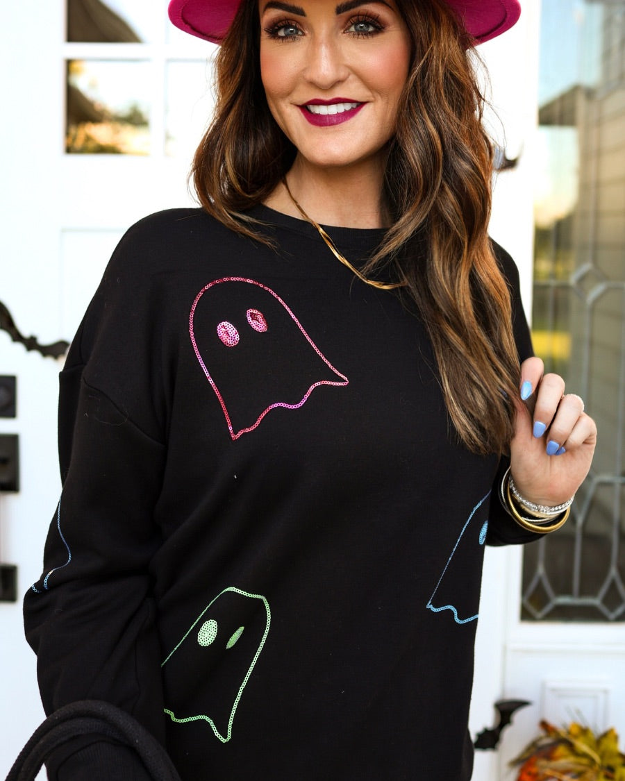 a black long-sleeve pullover crafted from soft fabric with a crew neckline, dropped shoulders, ribbed cuffs, banded hem, relaxed fit, classic sweatshirt silhouette, and colorful sequin ghost outline pattern across the front, back, and sleeve