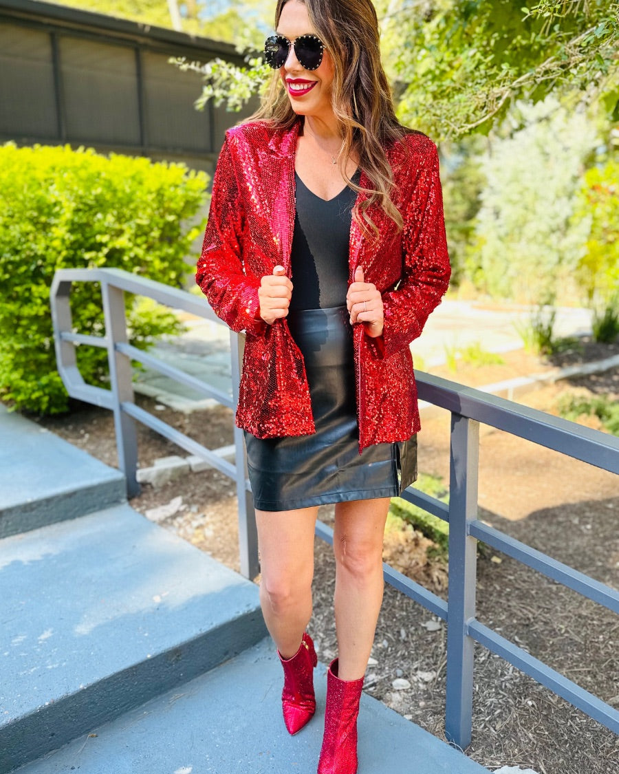 a full sequin-covered long-sleeve blazer with a structured collar, subtle shoulder pads, a smooth interior lining, and a center back vent in red