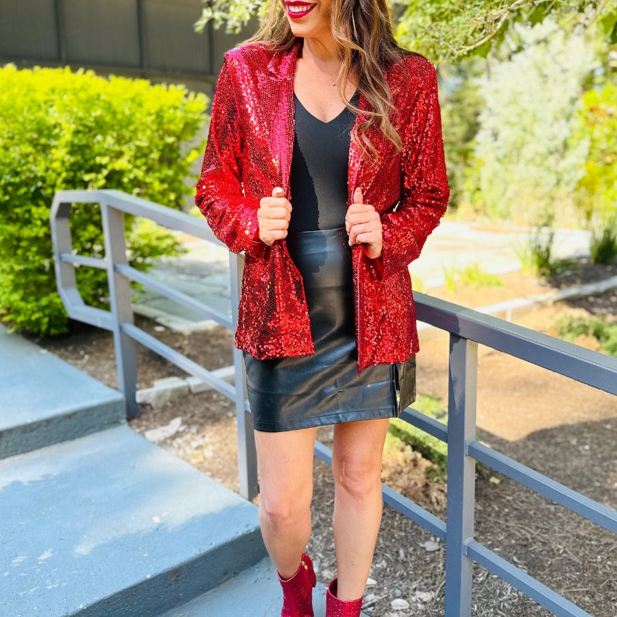 a full sequin-covered long-sleeve blazer with a structured collar, subtle shoulder pads, a smooth interior lining, and a center back vent in red