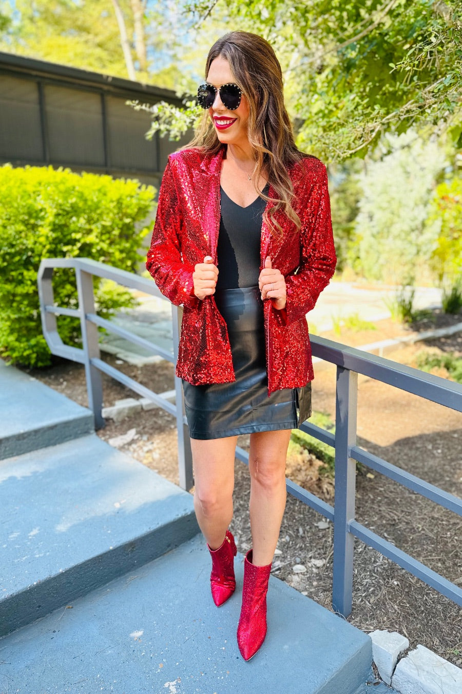 a full sequin-covered long-sleeve blazer with a structured collar, subtle shoulder pads, a smooth interior lining, and a center back vent in red