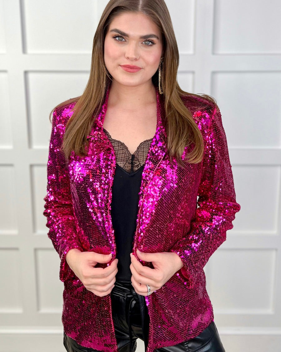a full sequin-covered long-sleeve blazer with a structured collar, subtle shoulder pads, a smooth interior lining, and a center back vent in pink
