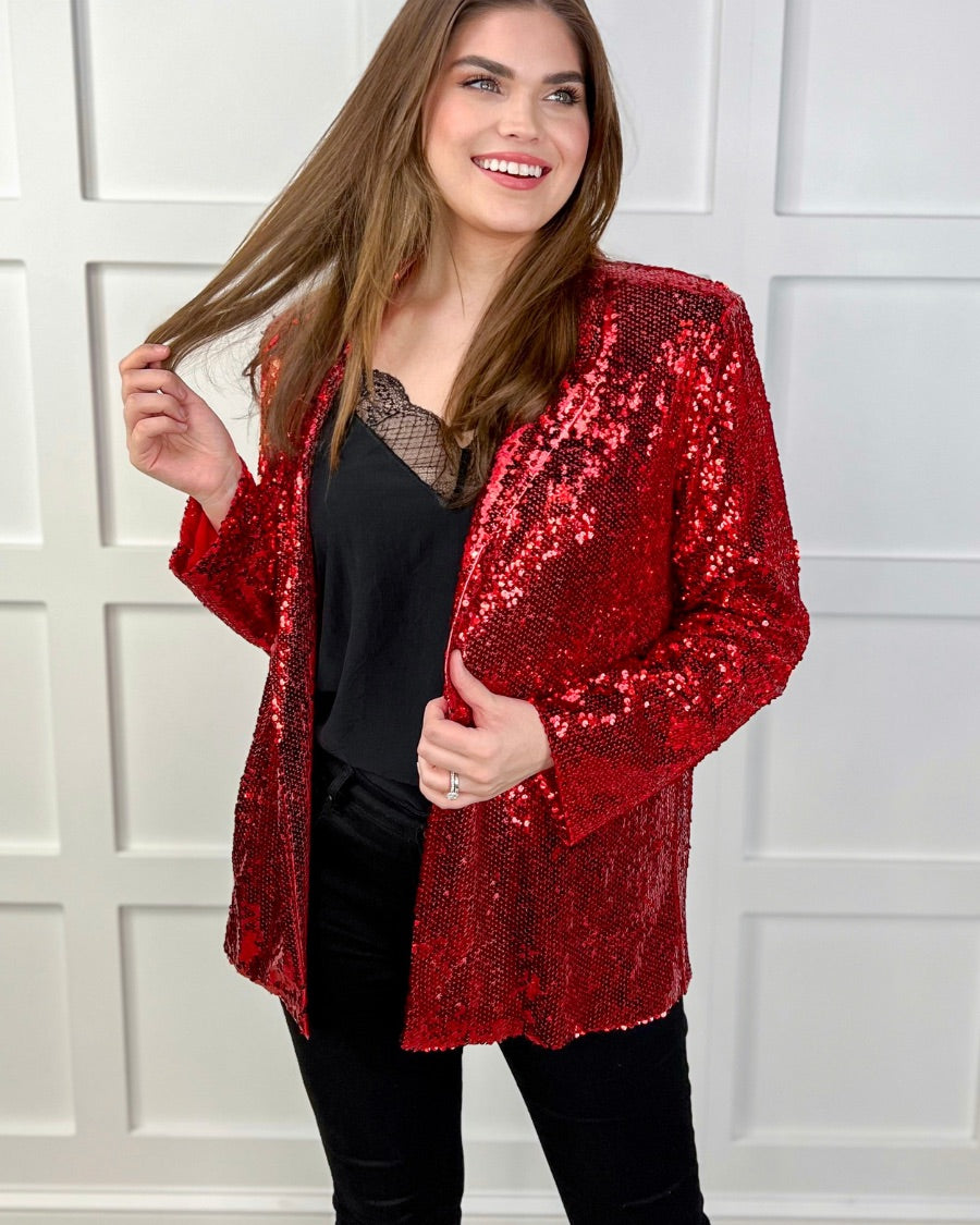 a full sequin-covered long-sleeve blazer with a structured collar, subtle shoulder pads, a smooth interior lining, and a center back vent in red