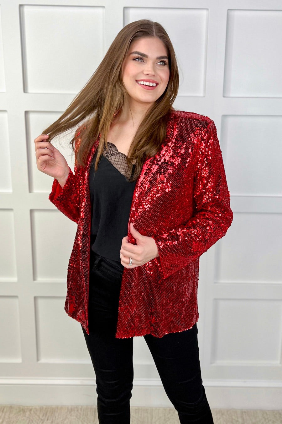 a full sequin-covered long-sleeve blazer with a structured collar, subtle shoulder pads, a smooth interior lining, and a center back vent in red