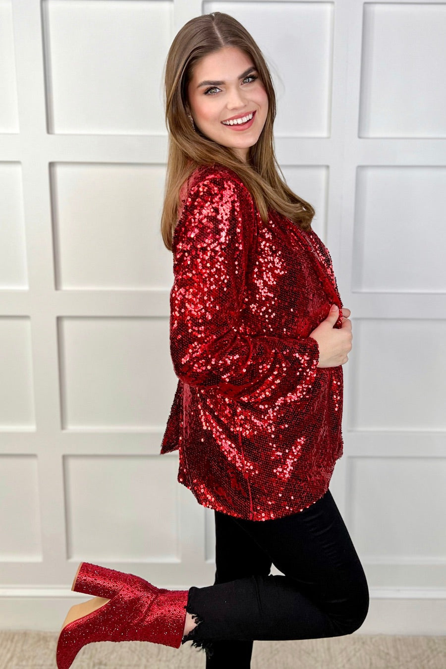 a full sequin-covered long-sleeve blazer with a structured collar, subtle shoulder pads, a smooth interior lining, and a center back vent in red