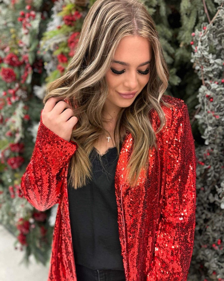 a full sequin-covered long-sleeve blazer with a structured collar, subtle shoulder pads, a smooth interior lining, and a center back vent in red