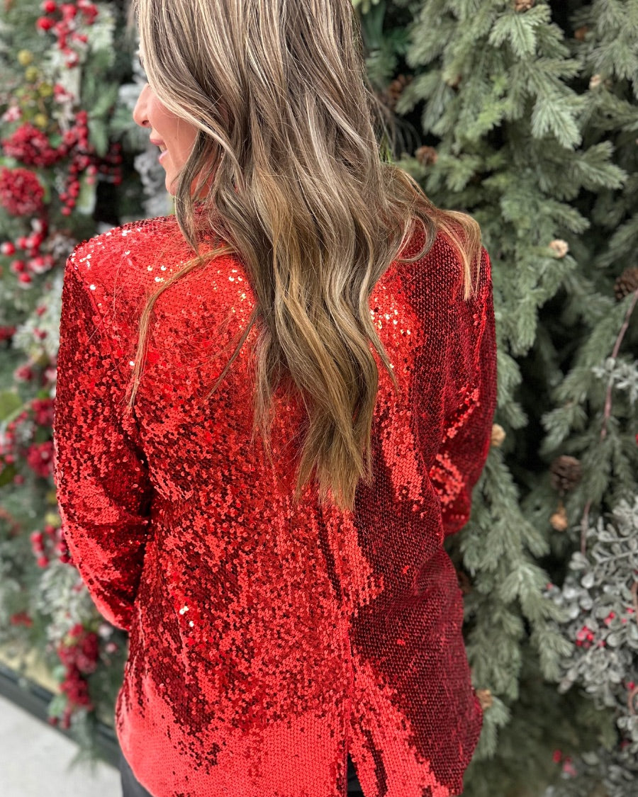 a full sequin-covered long-sleeve blazer with a structured collar, subtle shoulder pads, a smooth interior lining, and a center back vent in red