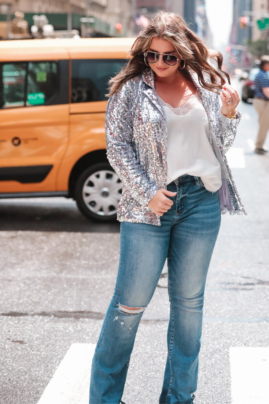 a full sequin-covered long-sleeve blazer with a structured collar, subtle shoulder pads, a smooth interior lining, and a center back vent in silver
