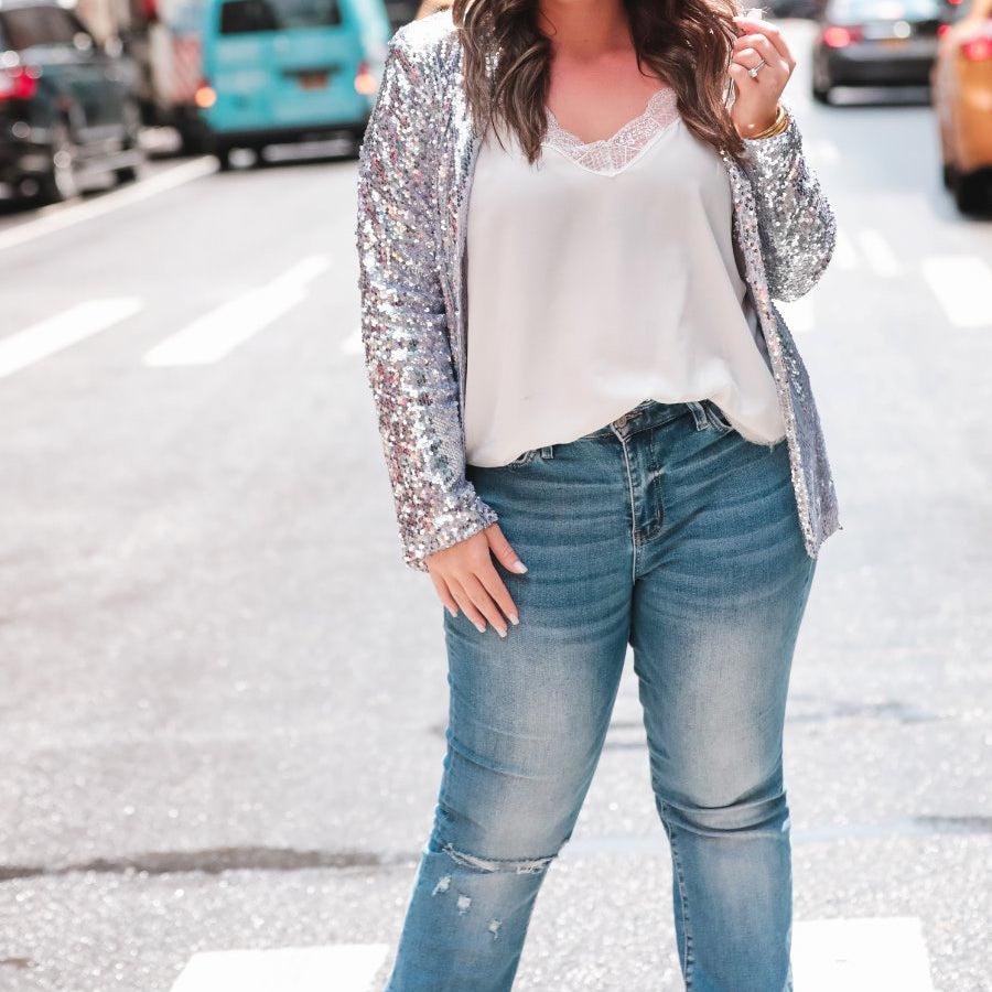 a full sequin-covered long-sleeve blazer with a structured collar, subtle shoulder pads, a smooth interior lining, and a center back vent in silver