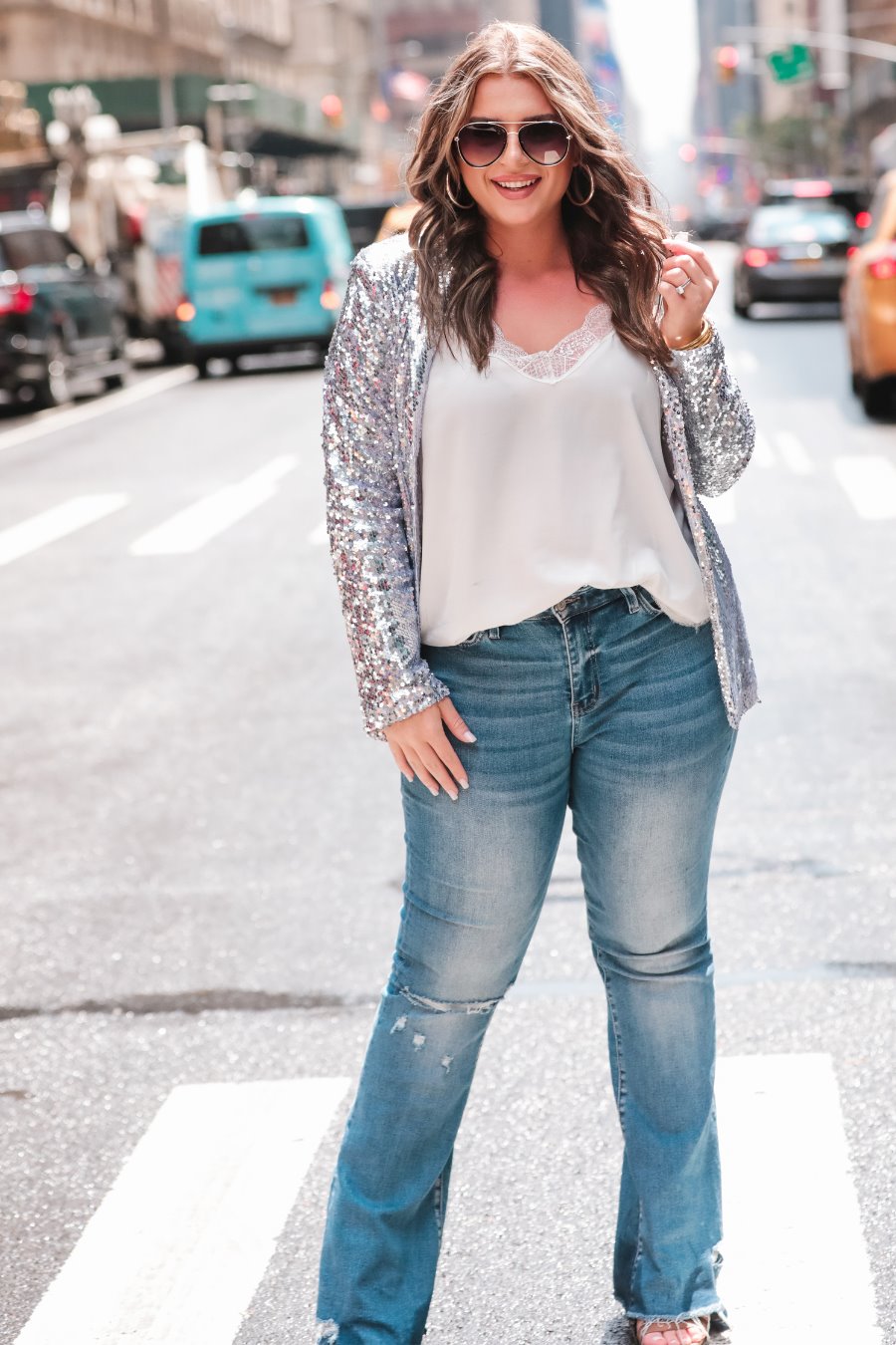 a full sequin-covered long-sleeve blazer with a structured collar, subtle shoulder pads, a smooth interior lining, and a center back vent in silver