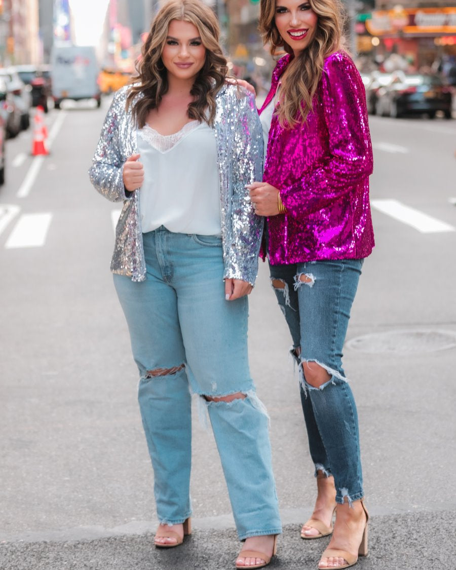 a full sequin-covered long-sleeve blazer with a structured collar, subtle shoulder pads, a smooth interior lining, and a center back vent in pink and silver