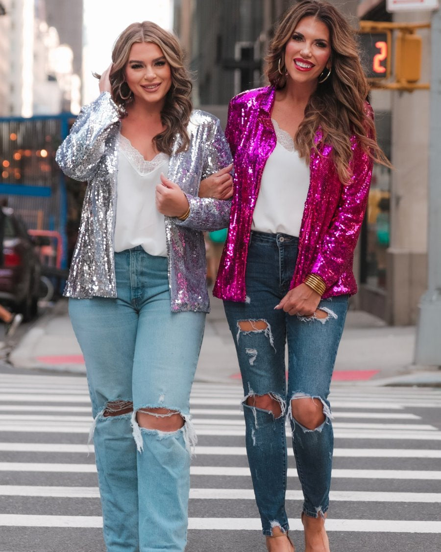 a full sequin-covered long-sleeve blazer with a structured collar, subtle shoulder pads, a smooth interior lining, and a center back vent in pink and silver