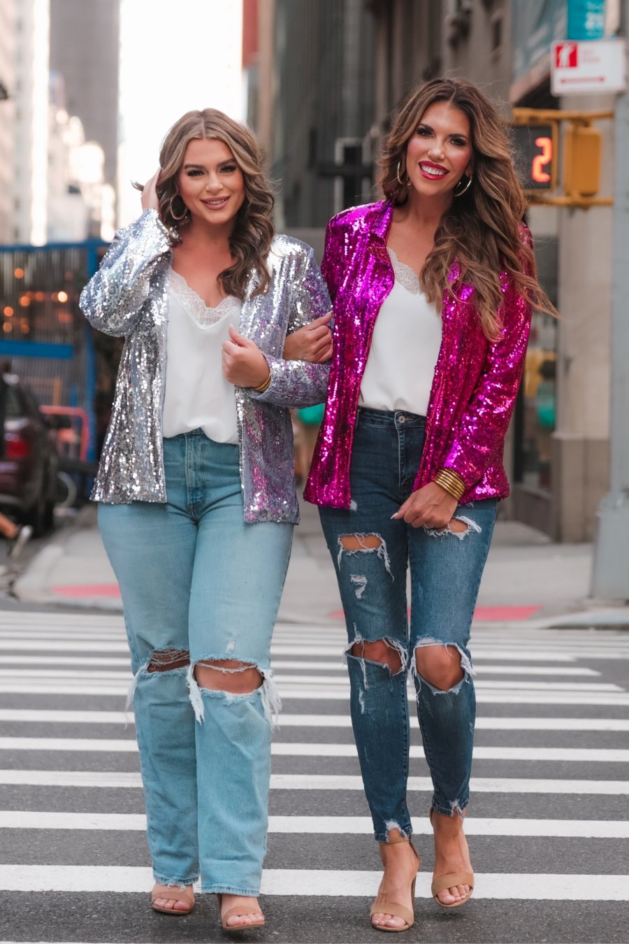 a full sequin-covered long-sleeve blazer with a structured collar, subtle shoulder pads, a smooth interior lining, and a center back vent in pink and silver