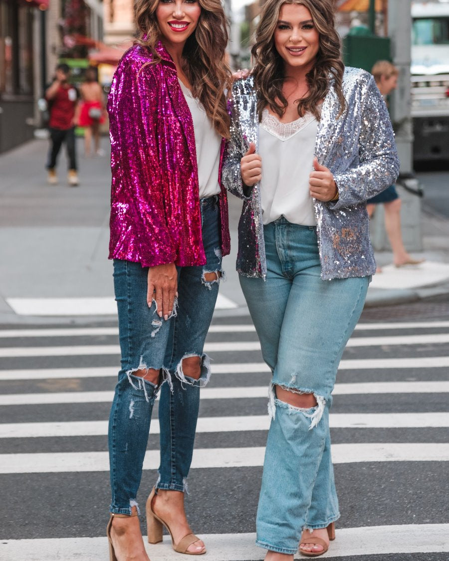 a full sequin-covered long-sleeve blazer with a structured collar, subtle shoulder pads, a smooth interior lining, and a center back vent in pink and silver