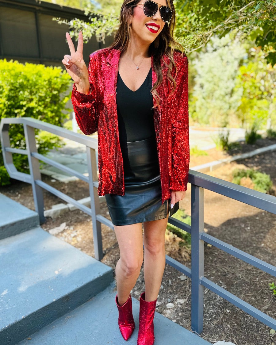 a full sequin-covered long-sleeve blazer with a structured collar, subtle shoulder pads, a smooth interior lining, and a center back vent in red