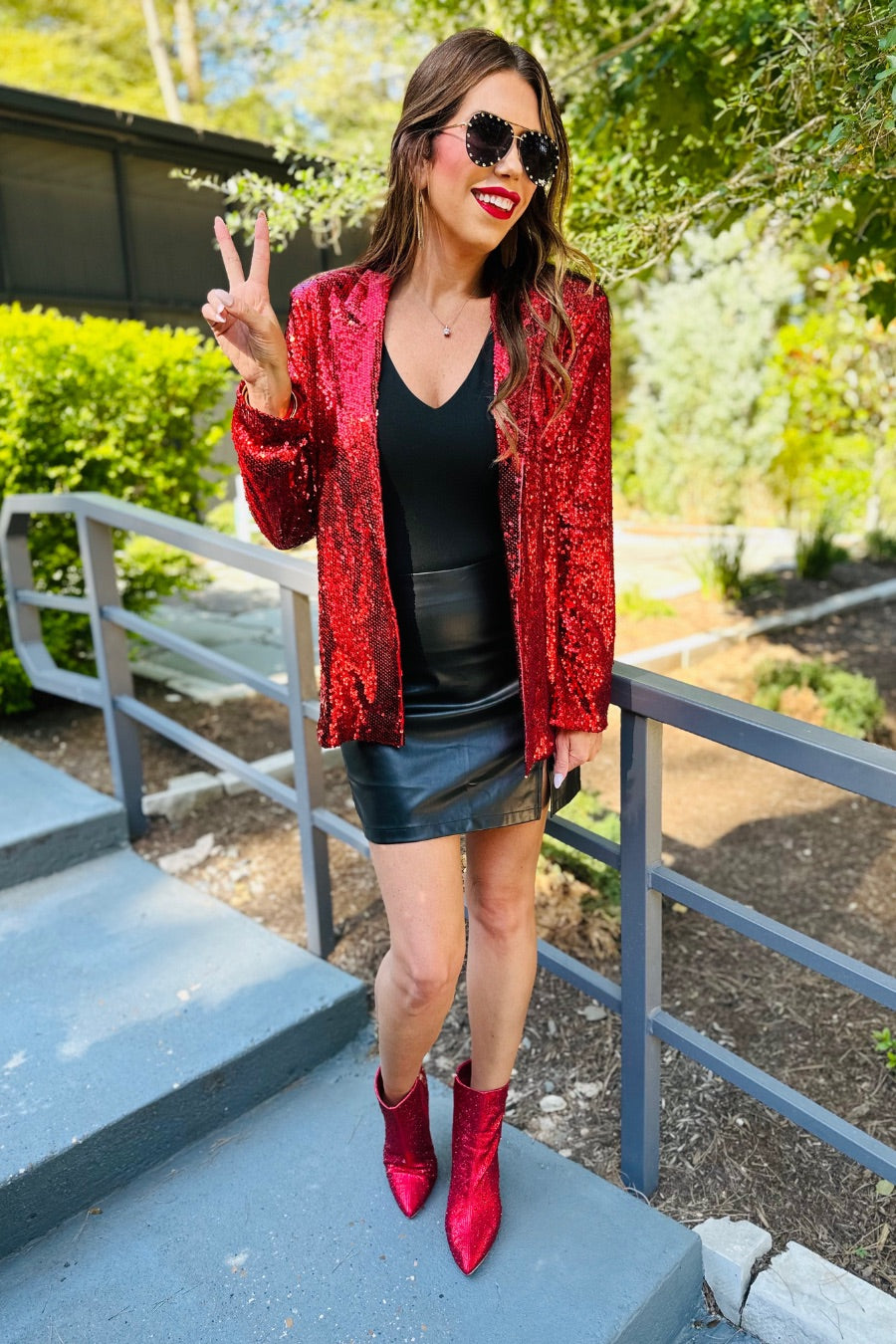 a full sequin-covered long-sleeve blazer with a structured collar, subtle shoulder pads, a smooth interior lining, and a center back vent in red