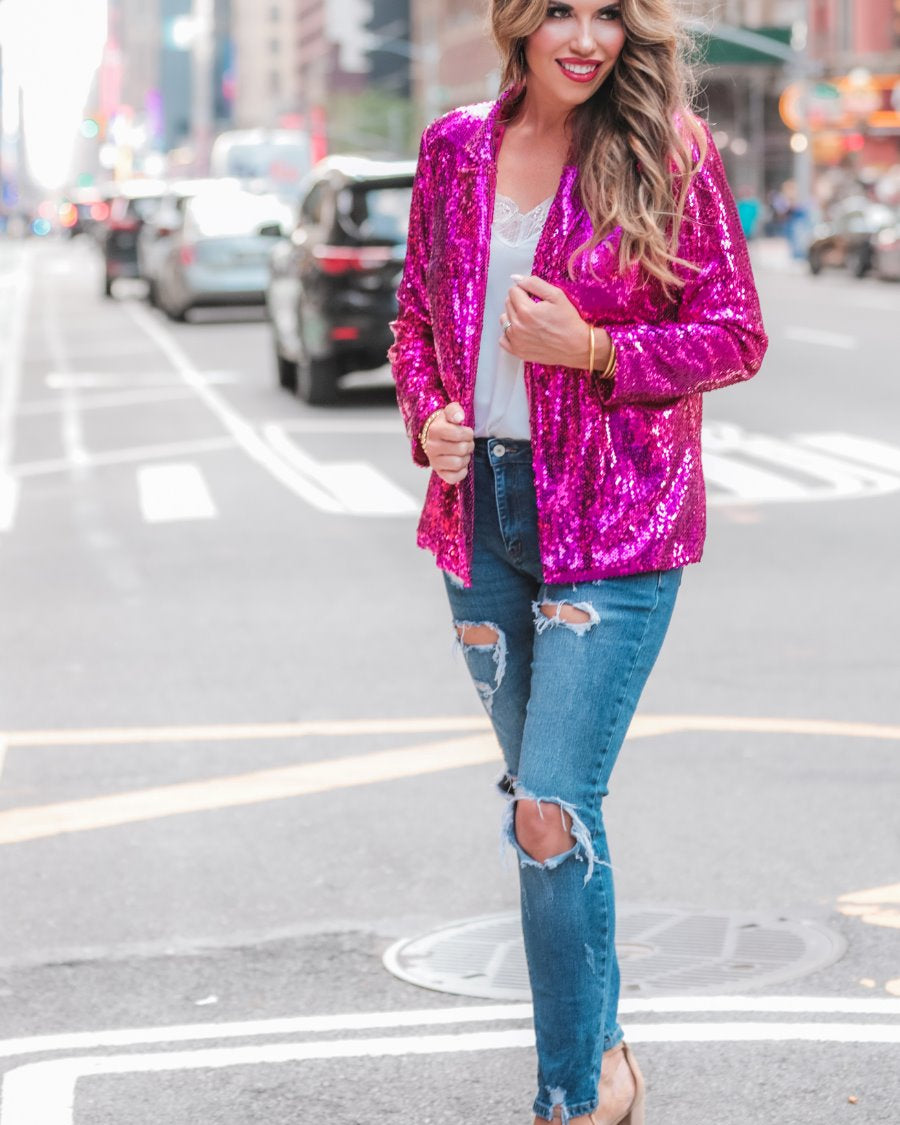 a full sequin-covered long-sleeve blazer with a structured collar, subtle shoulder pads, a smooth interior lining, and a center back vent in pink