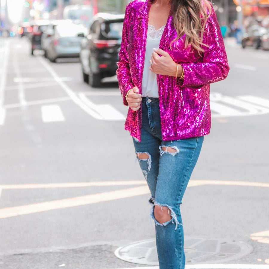a full sequin-covered long-sleeve blazer with a structured collar, subtle shoulder pads, a smooth interior lining, and a center back vent in pink